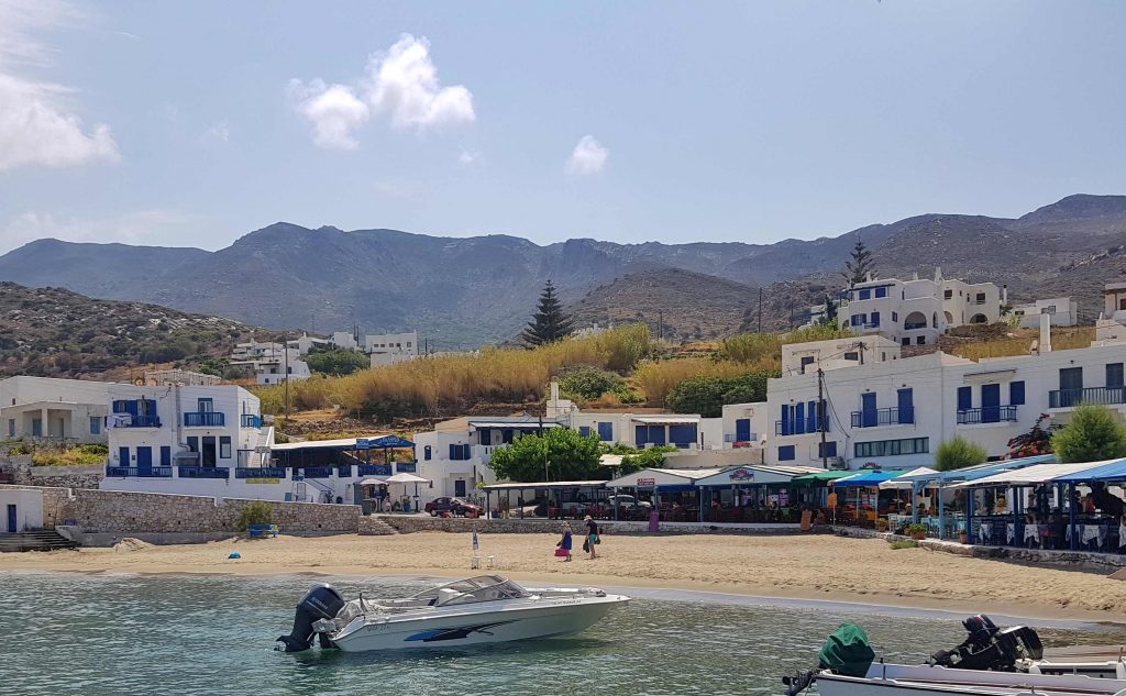 Naxos Greece: Travel Guide 2023 18 the bay at Apollonas Naxos and its beach side cafes as seen from the water, Naxos, Greece