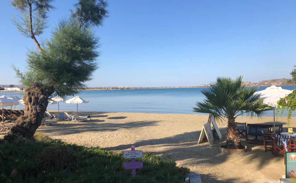 Naxos Greece: Travel Guide 2023 5 A phot of Agios Georges beach early in the morning on a sunny day, Naxos, Greece