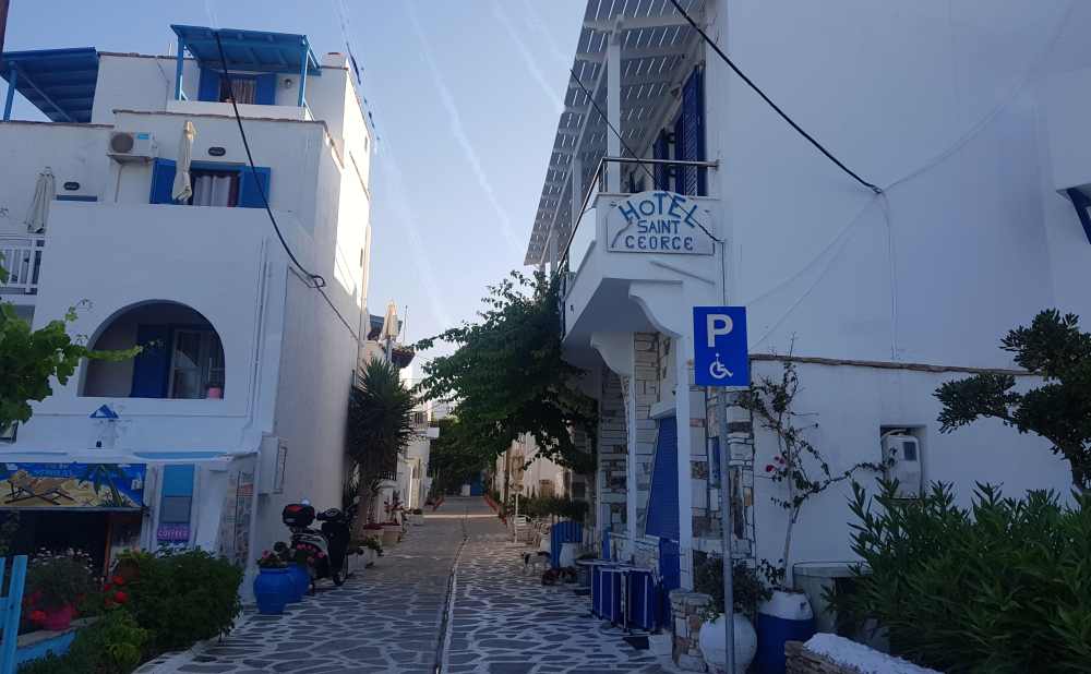 Naxos Greece: Travel Guide 2023 25 Photo of the blue and white Hotel Saint George, Agios Georgios, Naxos, Greece